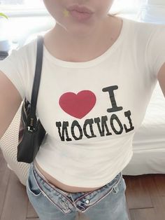 a young woman wearing a t - shirt with the word i love london printed on it