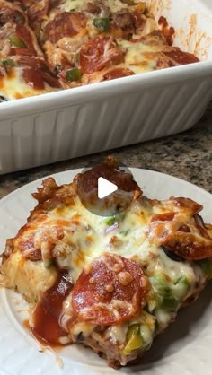 a slice of pizza on a plate next to a casserole dish