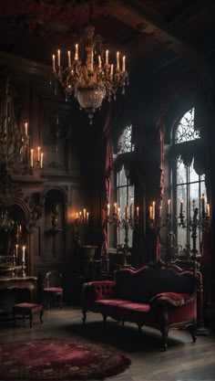 an old fashioned living room with chandelier and red velvet couches in front of large windows