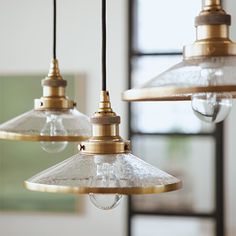 three light fixtures hanging from a ceiling