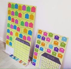 two colorful bulletin boards are next to each other on the floor in front of a white wall