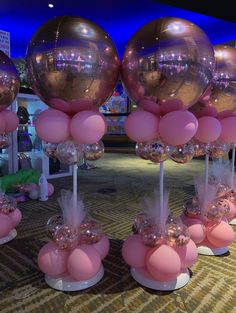 some pink and gold balloons are on display