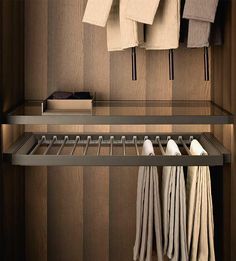 an organized closet with folded towels hanging on hooks