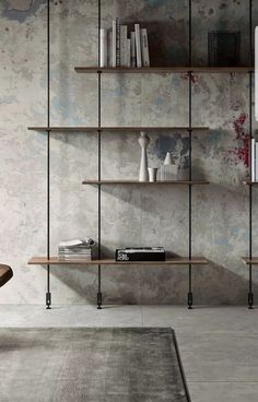 an empty room with shelves and books on the wall