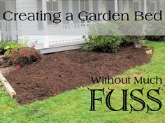 a garden bed with mulch and grass in front of a white house that says, creating a garden bed without much fusss