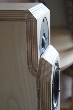 two wooden speakers sitting next to each other