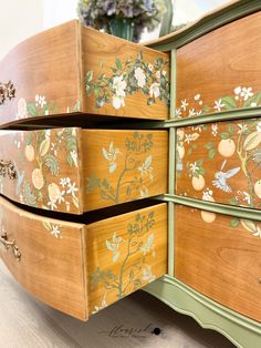 the drawers are painted with flowers and leaves