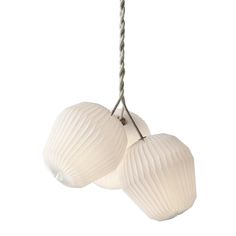 two white paper lanterns hanging from a rope