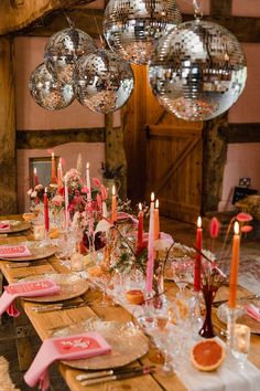 a long table with plates and candles on it