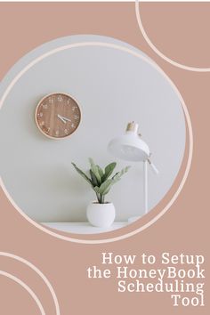 a white table topped with a clock and a plant