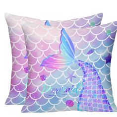 two pillows with mermaids on them, one is blue and the other is pink