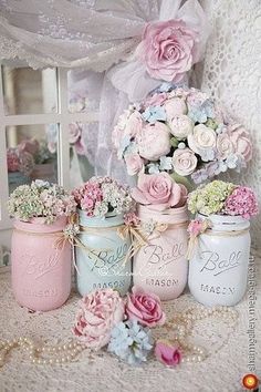 there are many jars with flowers in them