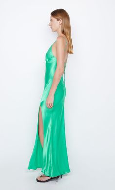 A statement eventwear style, the BEC + BRIDGE Ren Split Maxi Dress is cut on the bias from a lustrous speciality fabric. The dress features a thigh-high split, binding at bust, and fabric rouleau straps that feed through loops and finish at a low-cut, cross-back. This garment is certified Australian Made. Satin Maxi Dress With Fitted Bodice For Night Out, Fitted Satin Finish Maxi Dress For Gala, Formal Floor-length Slip Dress With Side Slits, Fitted Bias Cut Satin Maxi Dress, Evening Floor-length Slip Dress With Side Slits, Fitted Satin Finish Maxi Evening Dress, Evening Gala Satin Maxi Dress, Fitted Satin Maxi Slip Dress, Green Dress With Back Opening For Party