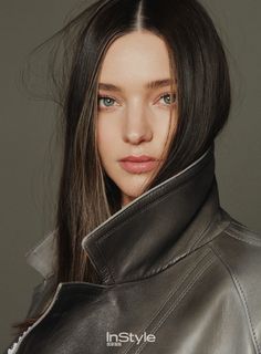 a woman with long hair wearing a black leather jacket and posing for an instyle magazine