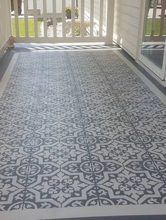 a porch with an intricate tile pattern on the floor