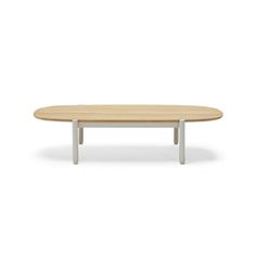 an oval table with white legs and a light wood top, on a white background