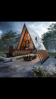 a small wooden cabin in the middle of a forest with a car parked next to it