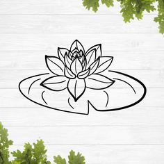 a black and white drawing of a lotus flower on top of a wooden surface with leaves