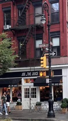 people walking on the sidewalk in front of a building