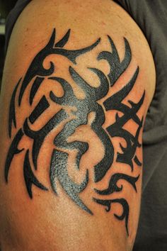 a man's arm with a tattoo design on the back of his arm and shoulder