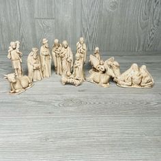 a nativity scene with figurines on a wooden surface