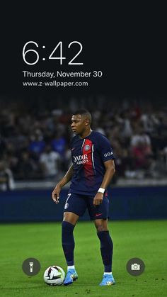 a man standing on top of a field next to a soccer ball