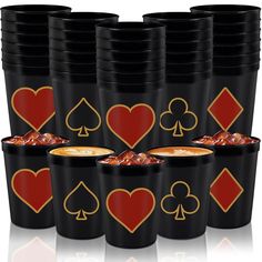 a stack of black cups with red and gold playing card symbols on them, all lined up in rows