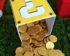 a bunch of gold coins sitting in front of a box with the number 3 on it