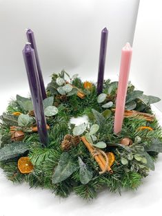 a wreath with three candles on top of it