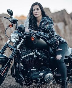 a woman sitting on top of a motorcycle