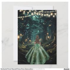 a card with a girl in a green dress and fairy lights on the tree branches