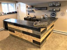 a bar made out of pallet wood with the word cheers on it