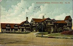 an old postcard shows the front of a large building with many windows and chimneys