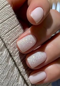 a woman's hand with pink and white manies on her nails, while she is