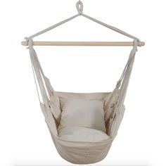 a white hanging chair with pillows on it