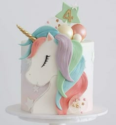 a white cake decorated with an unicorn's head