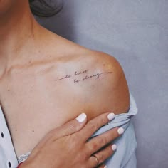 a woman with a tattoo on her shoulder that says, we have to be happy