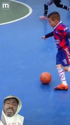 a man standing in front of a soccer ball on a blue court next to another person