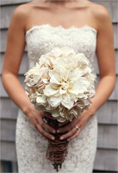 a woman holding a bouquet of flowers in her hands