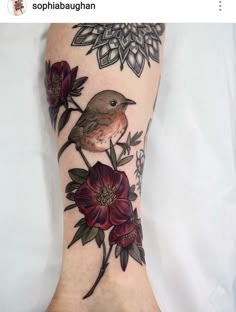 a bird and flowers tattoo on the foot