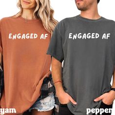 two people standing next to each other wearing t - shirts with the words engaged af on them