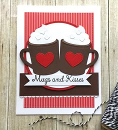 a close up of a card with two coffee mugs on it and the words hugs and kisses