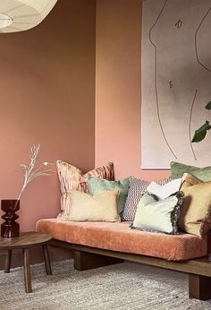 a living room filled with lots of furniture and pillows on top of a wooden table