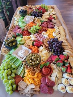 a table topped with lots of different types of cheese and crackers on top of it