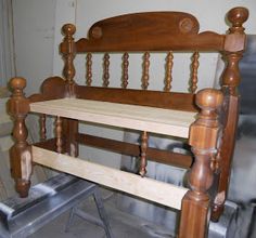 an old wooden bed frame sitting in a room