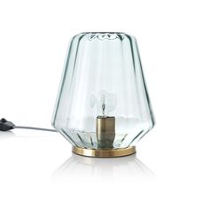 a glass lamp with a metal base on a white surface, the light is turned off