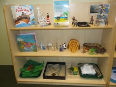 a book shelf filled with books and toys