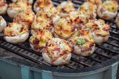 small stuffed mushrooms cooking on an outdoor grill