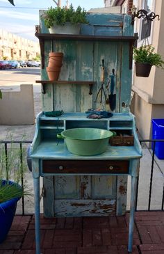 an old wooden table with a green bowl on it