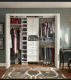 an open closet with clothes hanging on it